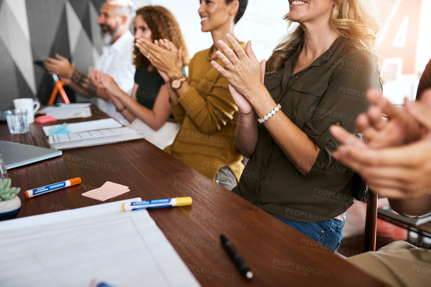 Buy stock photo Cropped shot of an unrecognizable group of businesspeople applauding in an office