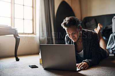 Buy stock photo Man, laptop and studying at house with internet for online course, research and reading for knowledge. Male student, computer and home with web for elearning or university, streaming with web app