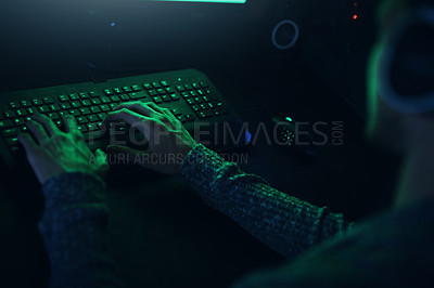 Buy stock photo Shot of an unrecognizable  man typing on a keyboard in a dark room at home