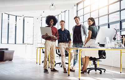 Buy stock photo Portrait of a team of happy designers working at a desk in their modern office