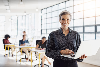 Buy stock photo Portrait of a happy designer posing in the office while her colleagues work in the background