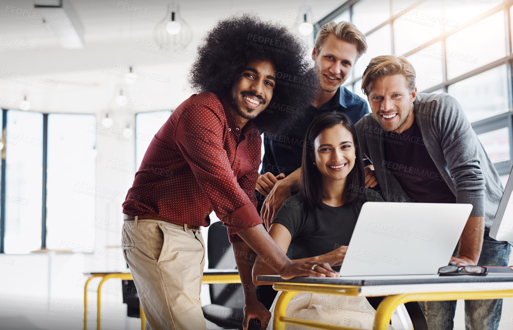 Buy stock photo Portrait of a team of happy designers working around a laptop in their modern office