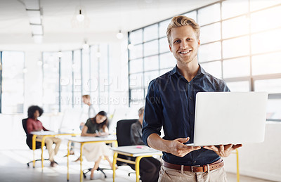Buy stock photo Portrait of a happy designer posing in the office while his colleagues work in the background
