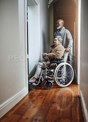 Buy stock photo Full length shot of a senior man pushing his wheelchair-bound wife through the house