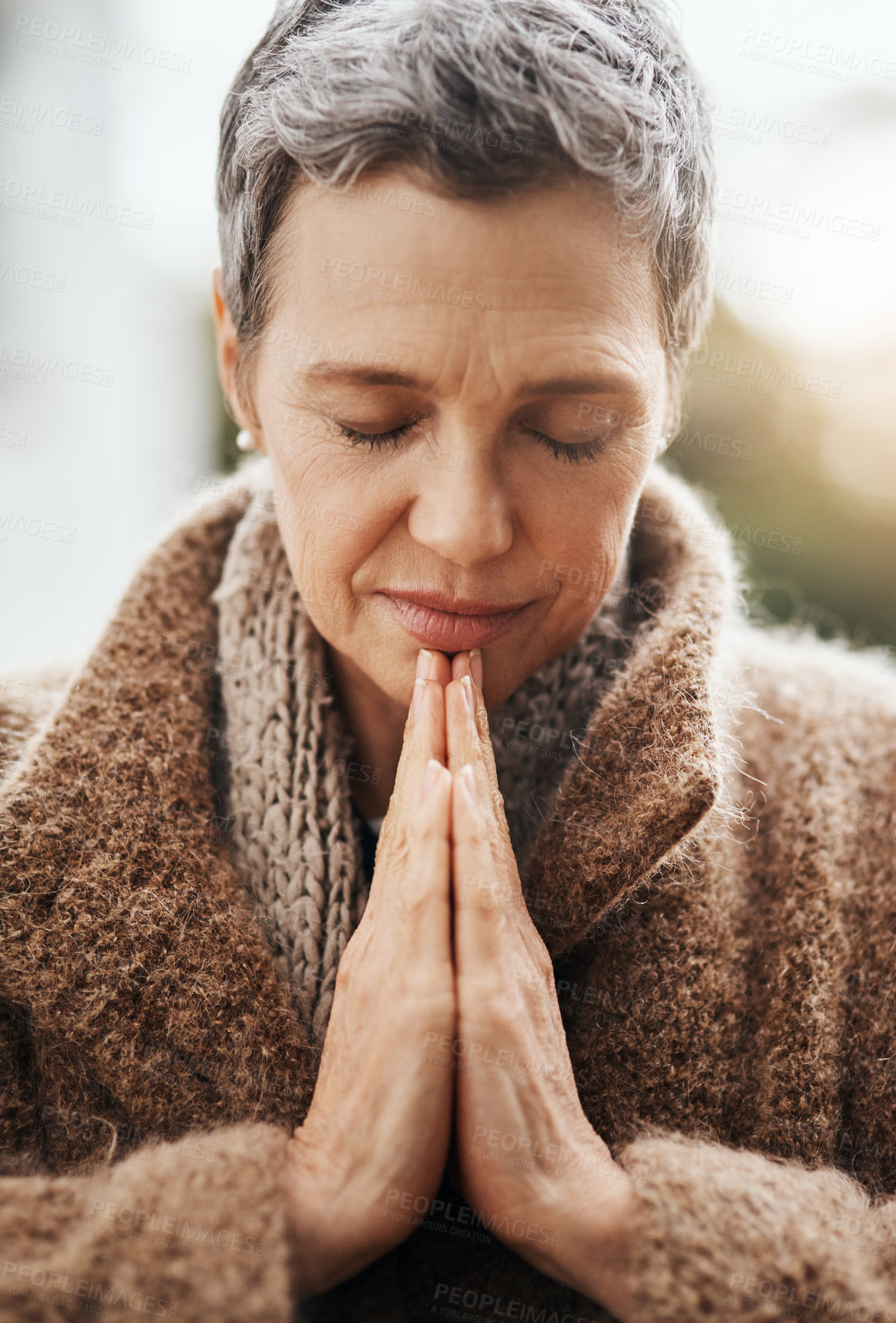 Buy stock photo Senior woman is praying, hands with worship and religion, God with peace, gratitude and faith outdoor. Spiritual female person in nature with face, eyes closed and prayer for guidance and blessing