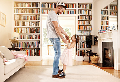 Buy stock photo Shot of a father dancing with his little daughter at home