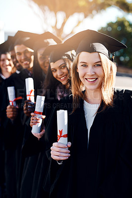 Buy stock photo Portrait of a group of students standing in a line on graduation day