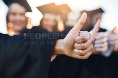 Buy stock photo Closeup shot of two unrecognizable students showing thumbs up on graduation day