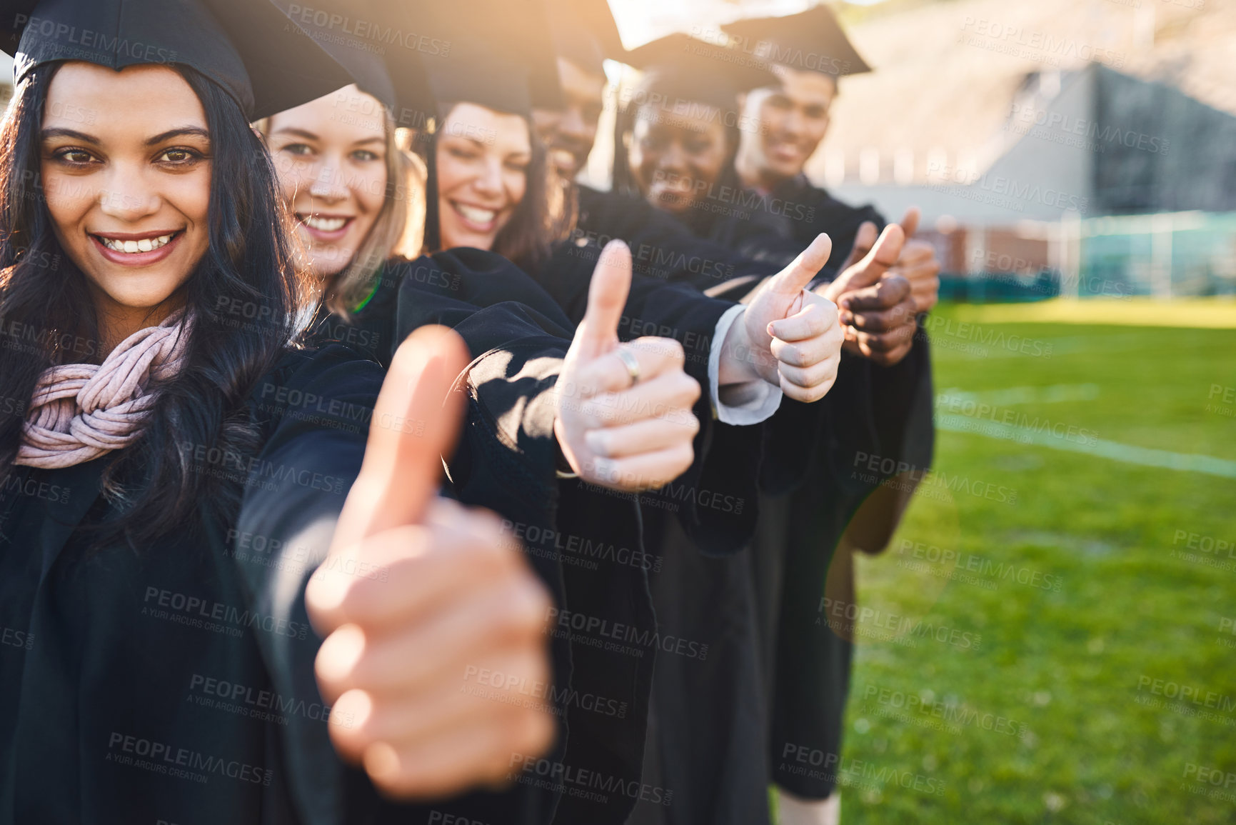 Buy stock photo Portrait of a group of students showing thumbs up on graduation day