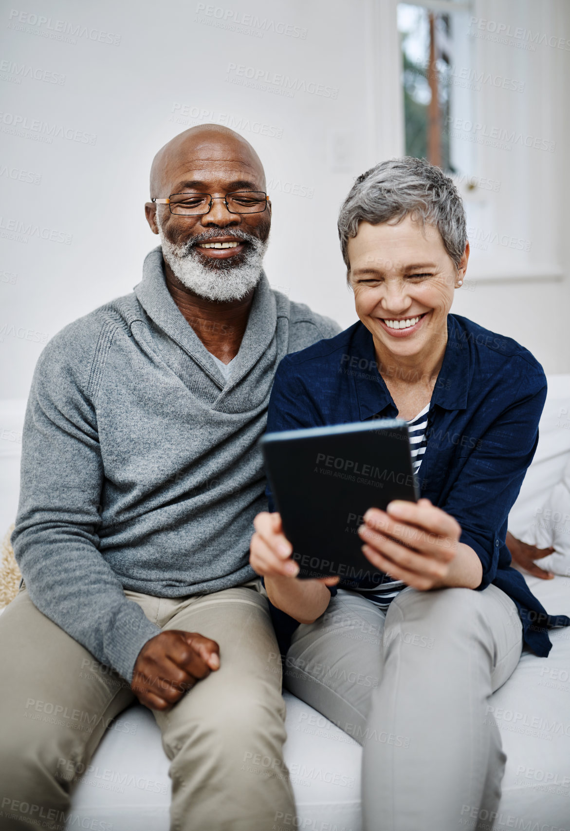 Buy stock photo Senior, couple and tablet in house together,  living room and browsing internet news or connection in apartment. Online, website and weekend or tech with interracial people, relationship and lounge