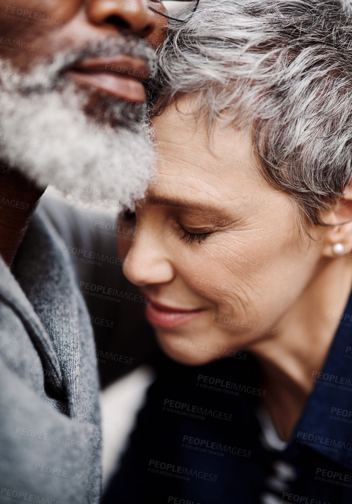 Buy stock photo Closeup up shot of an affectionate senior couple relaxing on the sofa at home