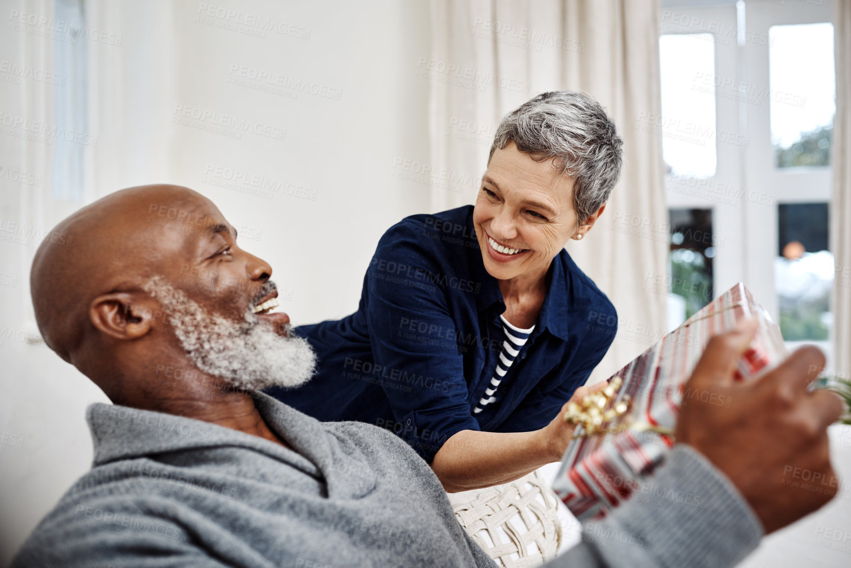 Buy stock photo Surprise, sofa and excited couple with gift to celebrate birthday, anniversary or gratitude in home. Love, mature woman and man on couch with present, giving and romantic marriage with care package