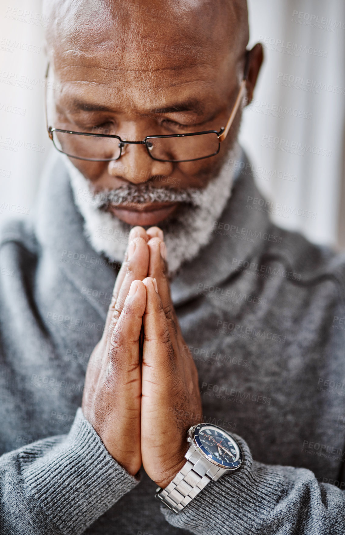 Buy stock photo Shot of a handsome senior man praying in his home