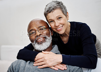 Buy stock photo Shot of an affectionate senior couple relaxing on the sofa at home