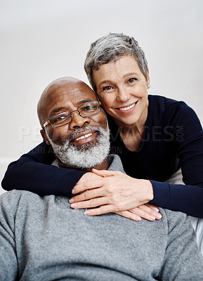 Buy stock photo Shot of an affectionate senior couple relaxing on the sofa at home