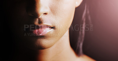 Buy stock photo Face, closeup of woman lips and in a black background for skincare with lens flare. Cosmetics or healthcare for skin, dermatology or treatment and female person in a studio backdrop with glow