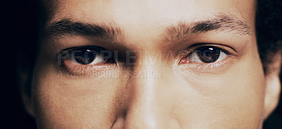 Buy stock photo Studio portrait of a man opening his eyes against a dark background
