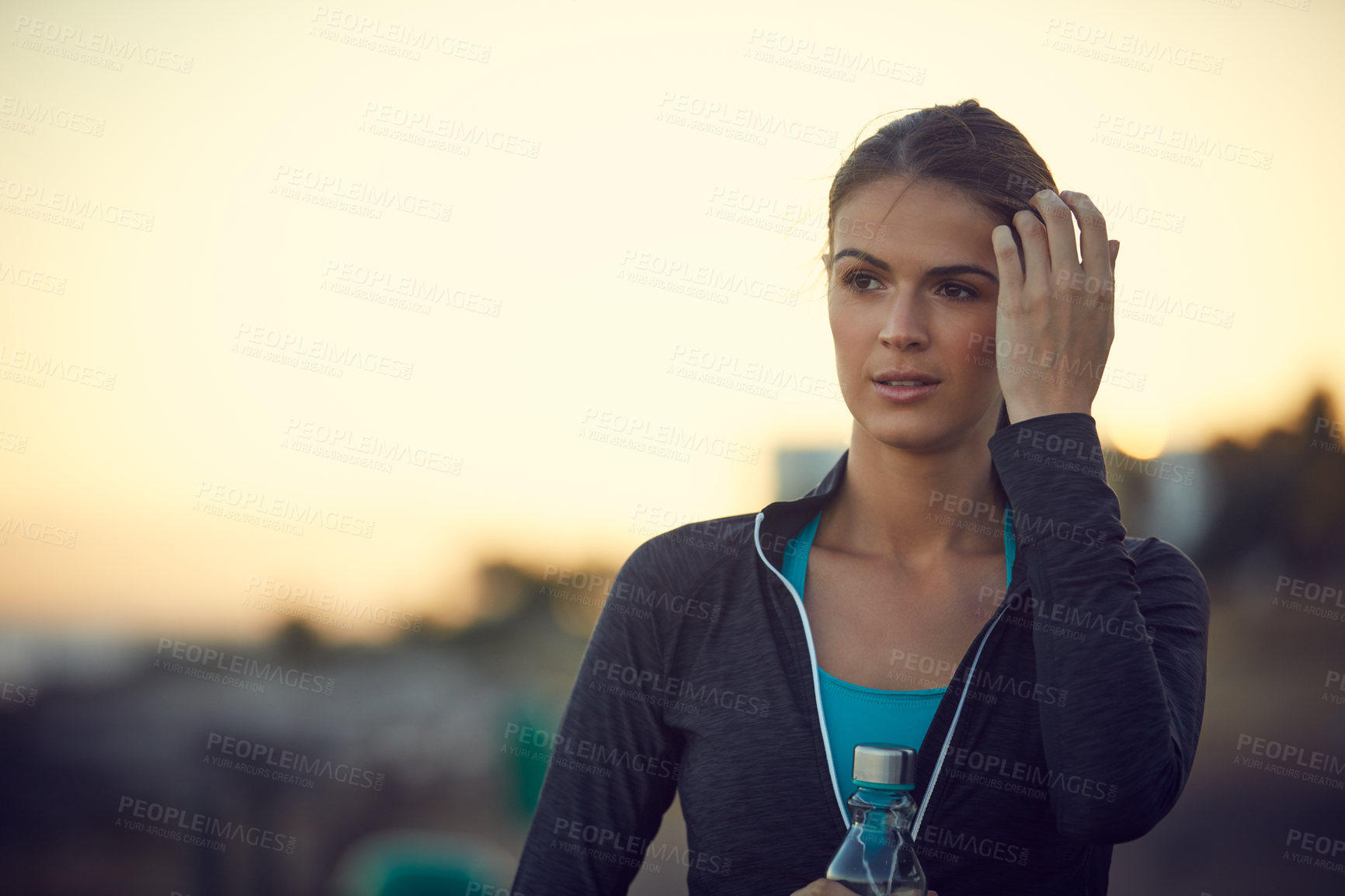 Buy stock photo Shot of a sporty young woman exercising outdoors