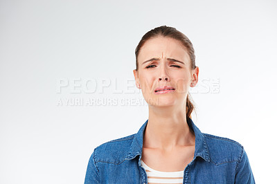 Buy stock photo Studio shot of a young woman crying against a grey background