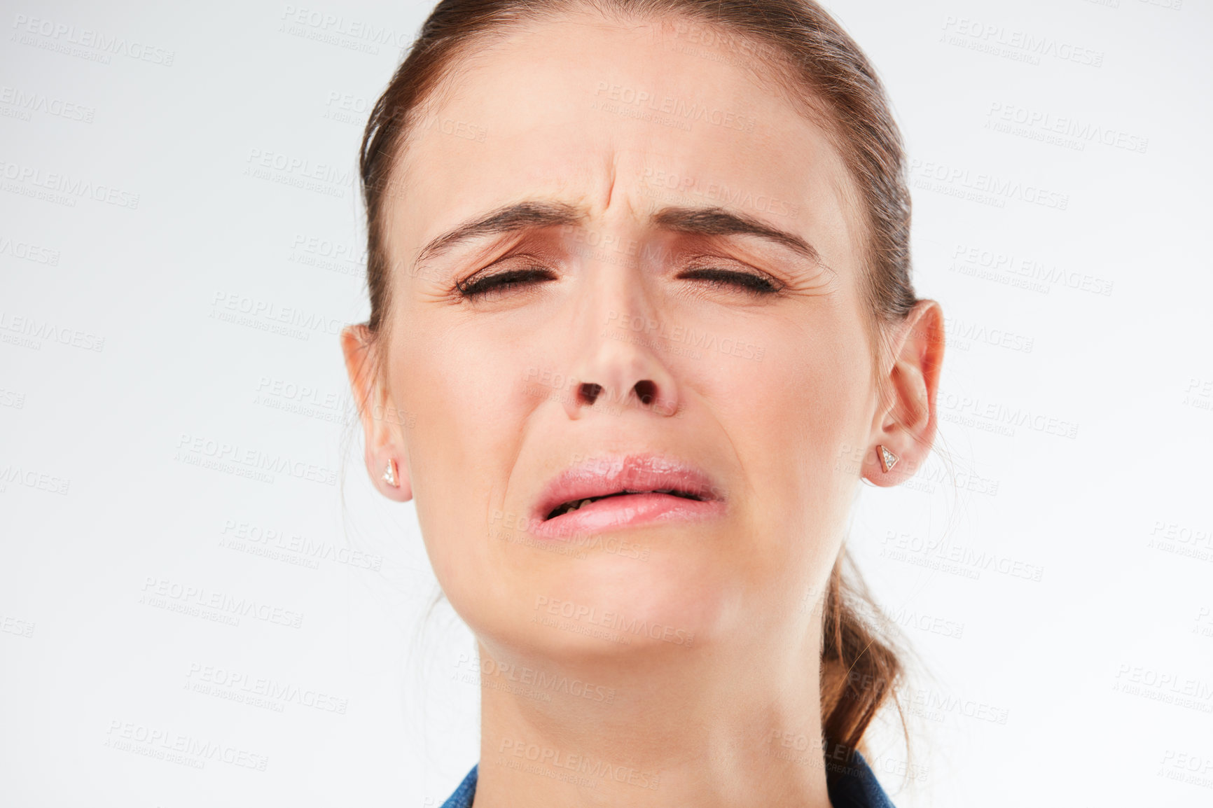 Buy stock photo Studio shot of a young woman crying against a grey background