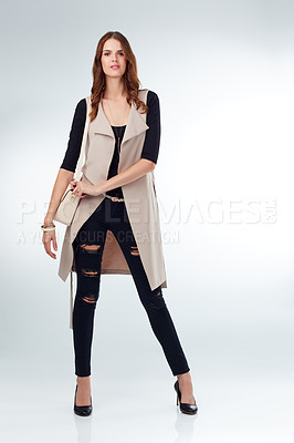 Buy stock photo Studio shot of an attractive young woman modeling fashion-wear against a grey background