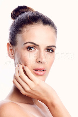 Buy stock photo Cropped shot of a beautiful young woman posing against a light background