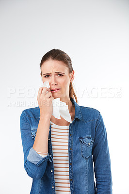 Buy stock photo Studio portrait of a young woman crying against a grey background