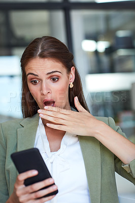 Buy stock photo Shot of a young businesswoman using a mobile phone and looking shocked in a modern office