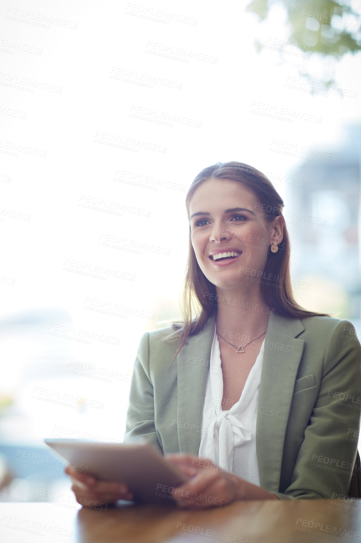 Buy stock photo Shot of a young businesswoman using a digital tablet in a modern office