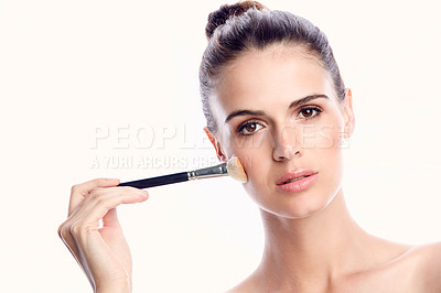 Buy stock photo Cropped shot of a beautiful young woman posing with a makeup brush against a white background