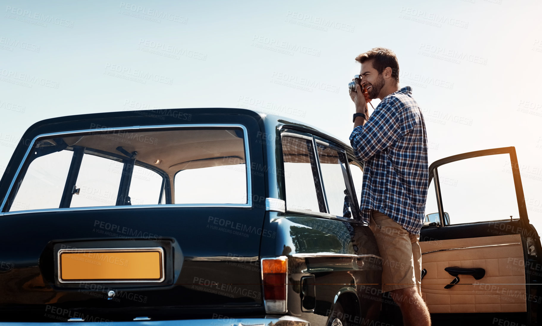 Buy stock photo Outdoor, photography and man with camera on road trip, adventure and holiday vacation in Spain. Nature, male traveler and photographer by car for memory, picture and tourist with vintage equipment