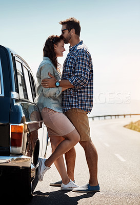 Buy stock photo Shot of an affectionate couple out on a road trip