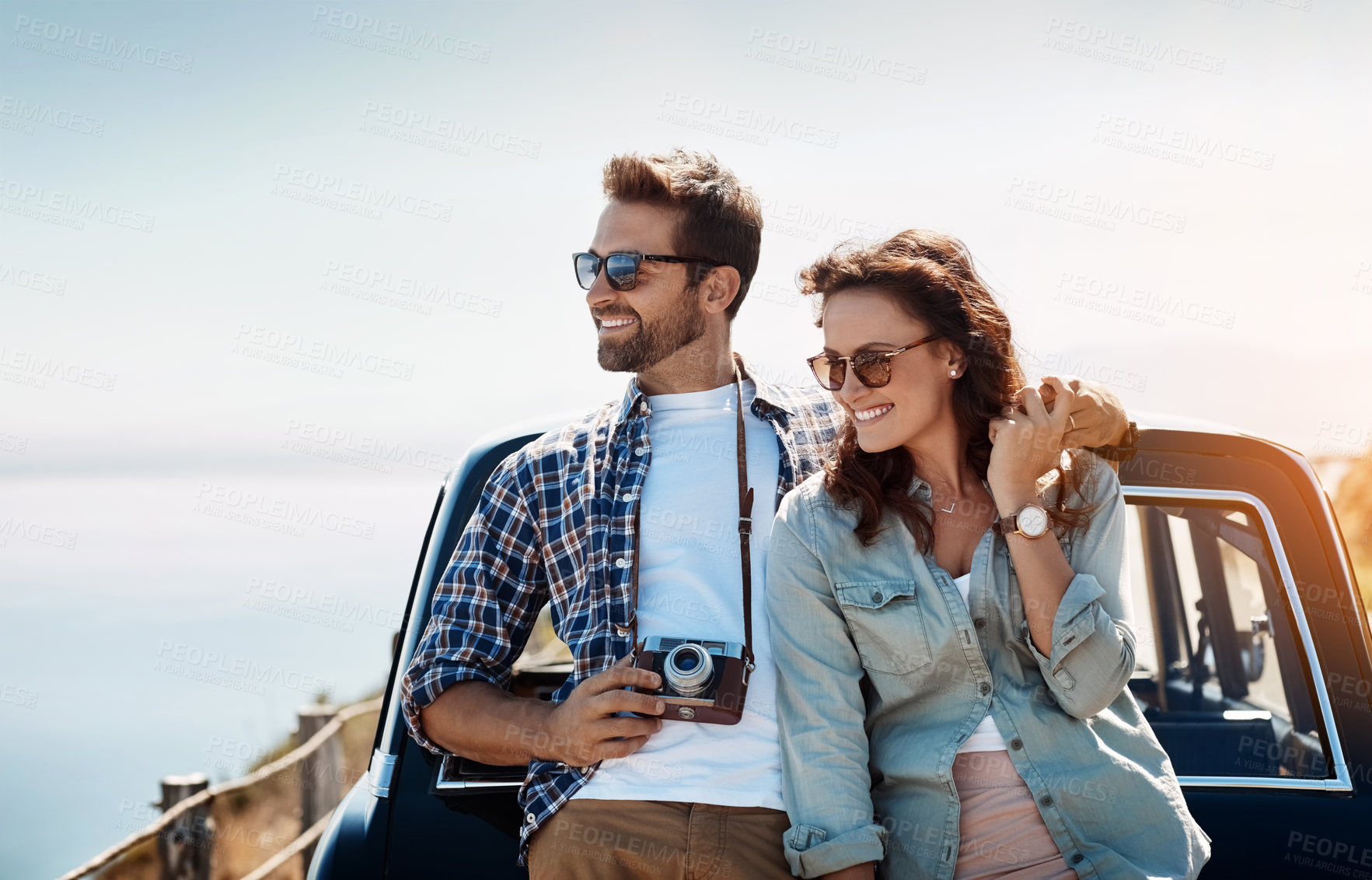 Buy stock photo Happy couple, nature and hug by car for road trip with camera for journey documentation, explore and bonding. Man, woman and together for scenic drive, travel photography and adventure with love.