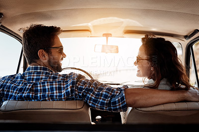 Buy stock photo Rearview shot of an affectionate couple enjoying a summer road trip