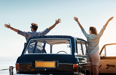Buy stock photo Rearview shot of a cheerful couple out on a road trip