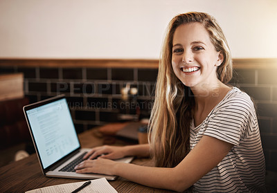 Buy stock photo Cropped portrait of a happy young student using her laptop to study at a tablet in a cafe