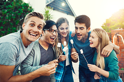 Buy stock photo Portrait of a group of young friends posing together and holding up marshmallows on sticks outside