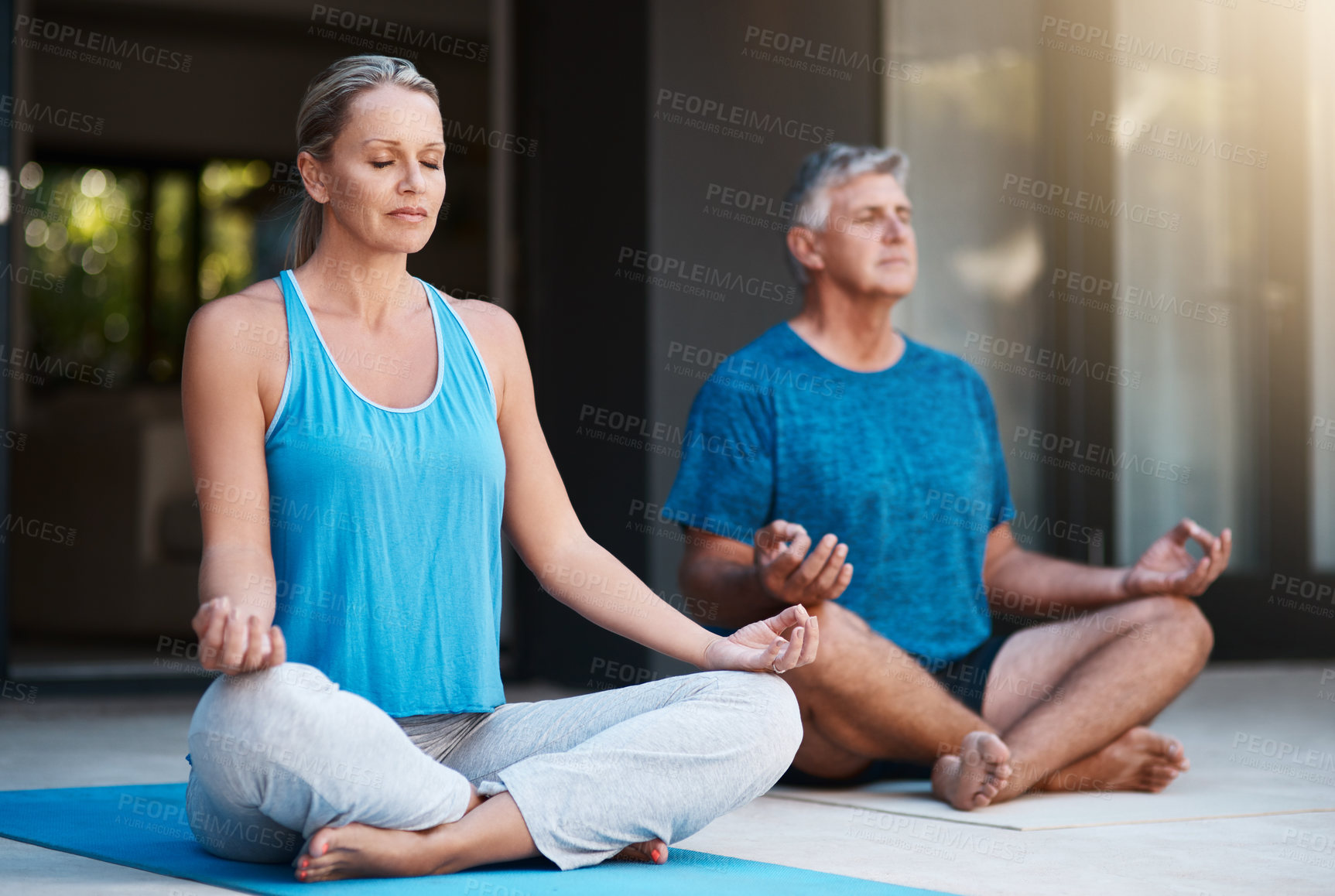 Buy stock photo Shot of a mature and happy couple meditating outside of their home in the morning