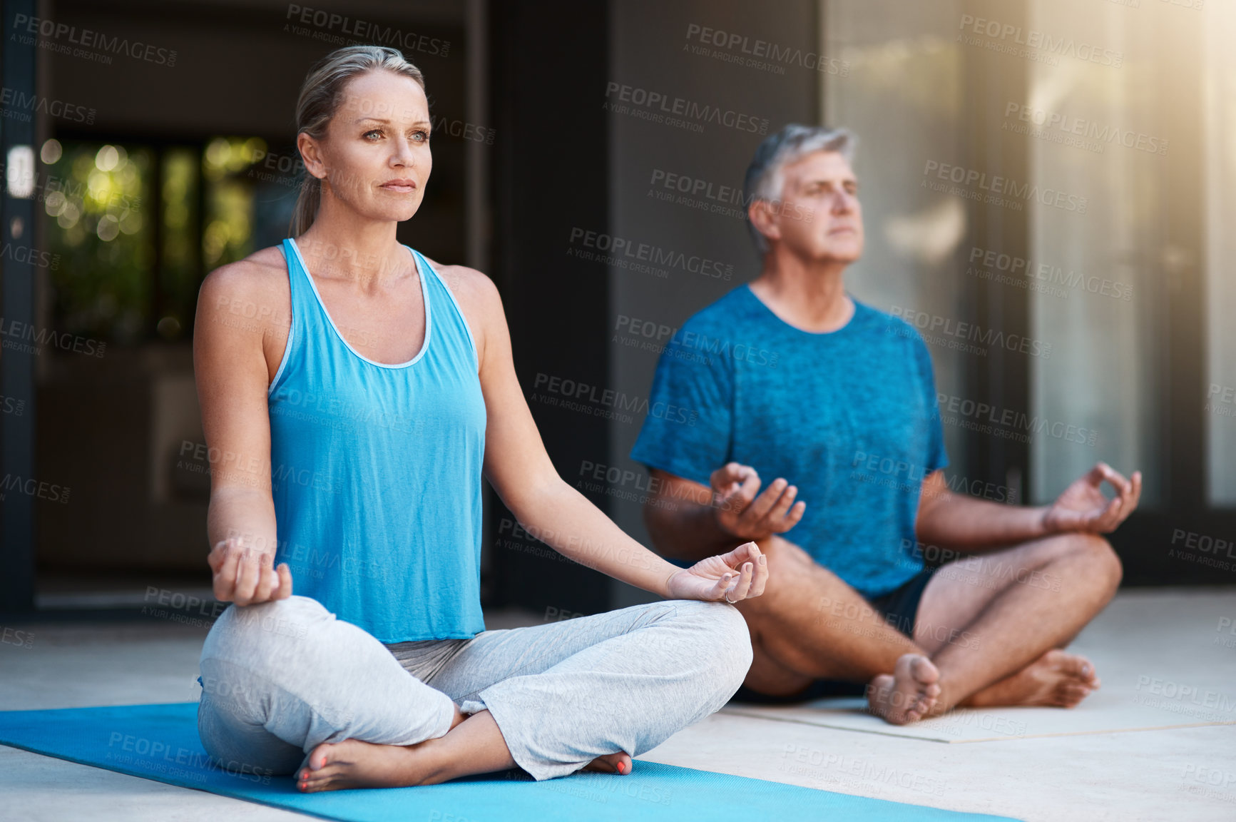 Buy stock photo Shot of a mature and happy couple meditating outside of their home in the morning