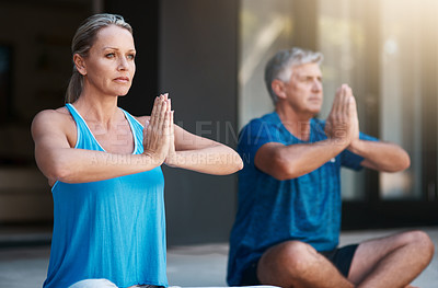Buy stock photo Shot of a mature and happy couple meditating outside of their home in the morning