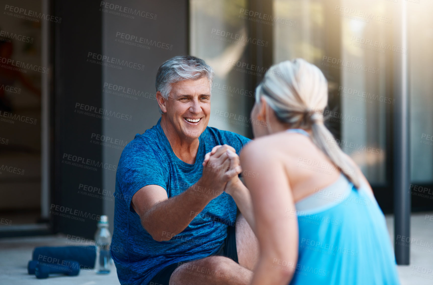 Buy stock photo Shot of a mature and motivated couple congratulating each other at the end of an intense workout session