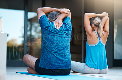 Buy stock photo Rearview shot of a mature couple stretching before they start their yoga exercises outside of their home