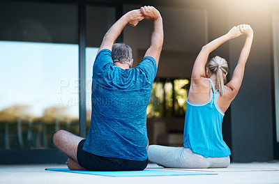 Buy stock photo Rearview shot of a mature couple stretching before they start their yoga exercises outside of their home