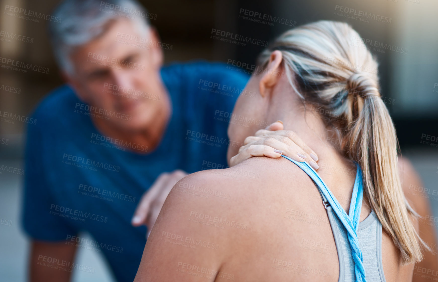 Buy stock photo Shot of a mature woman holding her neck in pain after an intense workout session with her husband