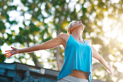 Buy stock photo Low angle shot of a mature woman feeling free and posing with her arms outstretched outdoors