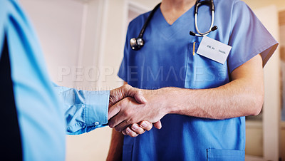 Buy stock photo Shot of an unrecognizable doctor shaking hands with a senior patient
