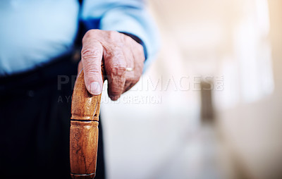 Buy stock photo Closeup shot of an unrecognizable senior man's hand holding onto a walking stick