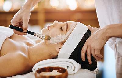 Buy stock photo Shot of an attractive young woman getting a facial at a beauty spa