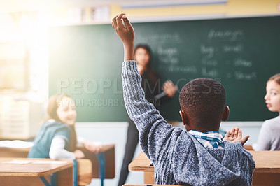 Buy stock photo Little boy, hands raised and classroom with question for teacher, answer or learning at elementary school. Back view, kid or young child with answer for interaction, engagement or attention in lesson