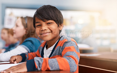 Buy stock photo Portrait, smile and boy in classroom for learning in growth, child development and notebook for education. Happy, lesson and face of student with exam notes, knowledge and study at elementary school